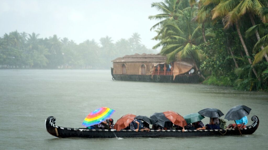Monsoon time People crossing a river by boat in rain Destinations Desire