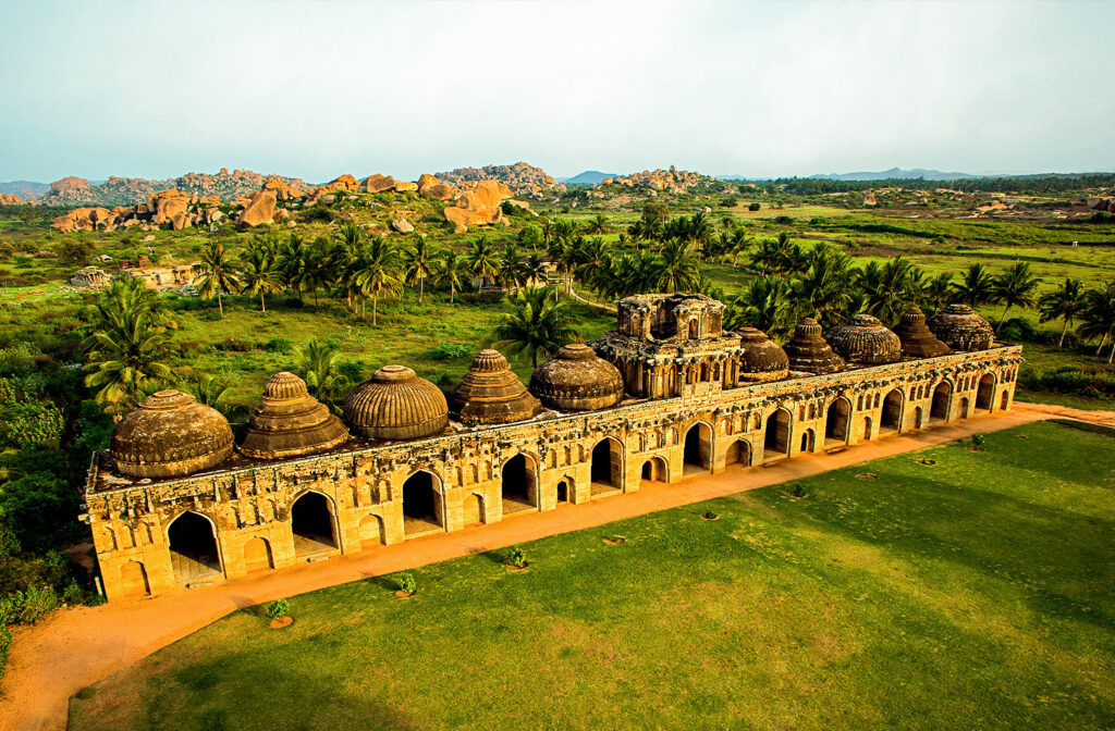 Destinations Desire Hampi temple ruins and boulder hills in golden light