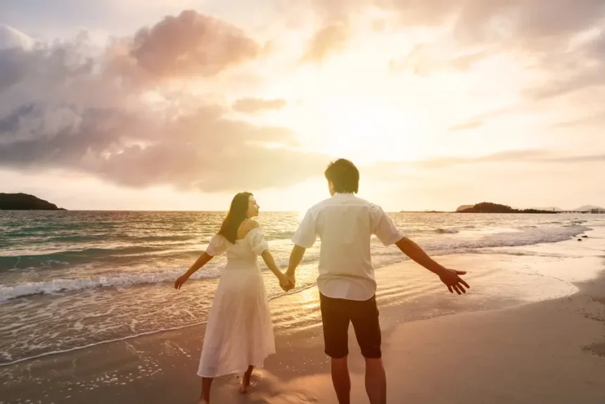 Couple walking on beach during Valentines vacation